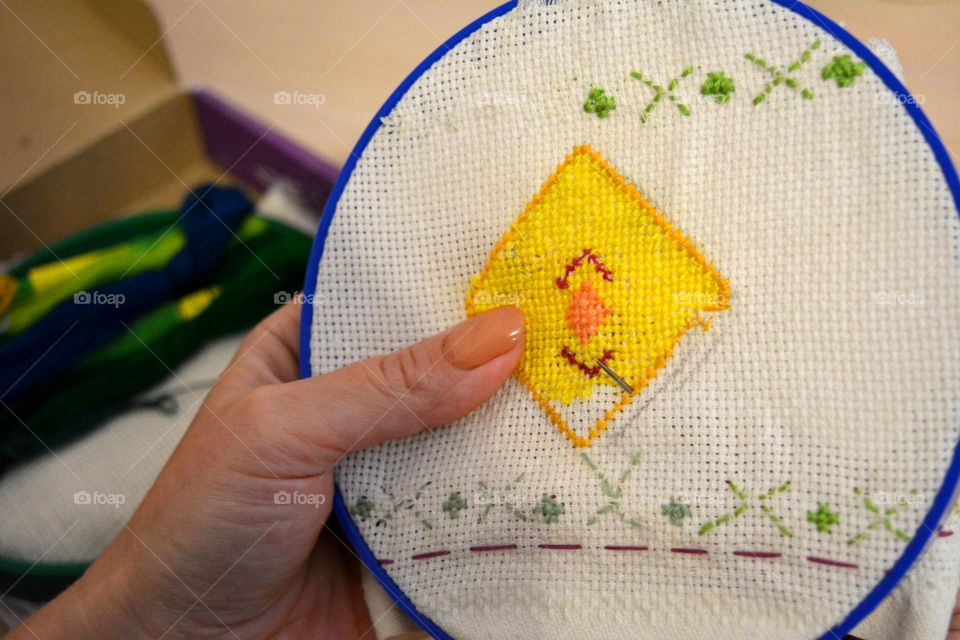 cross stitch in the female hand hobbies, art and craft