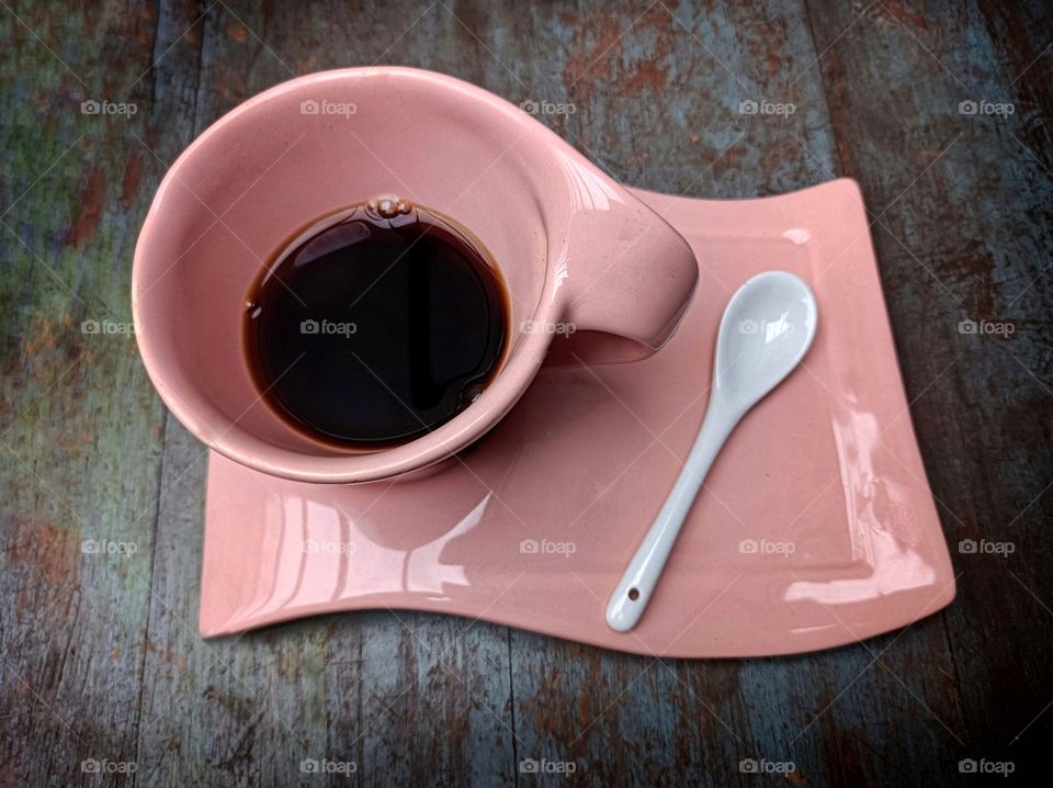 Black coffee in pink cup