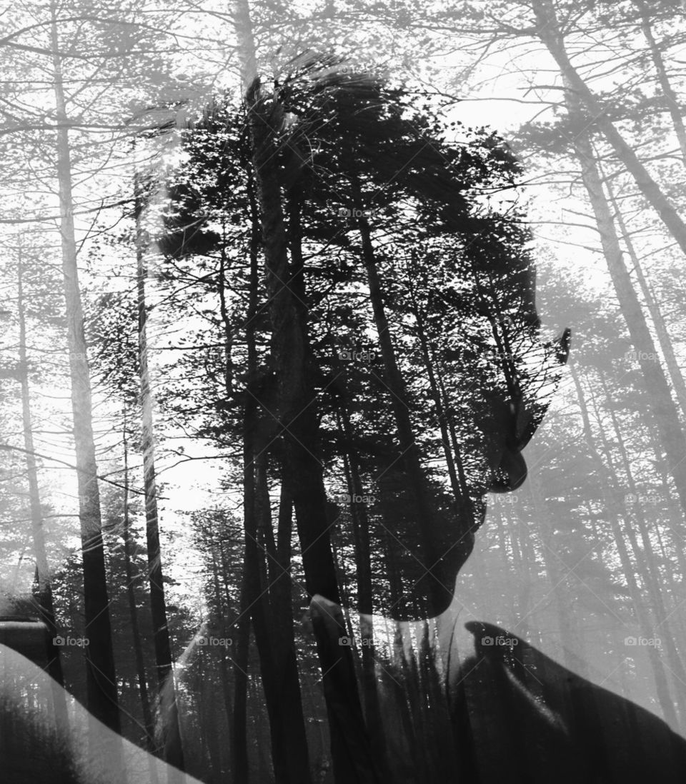abstract double exposured woman porttait in black forest