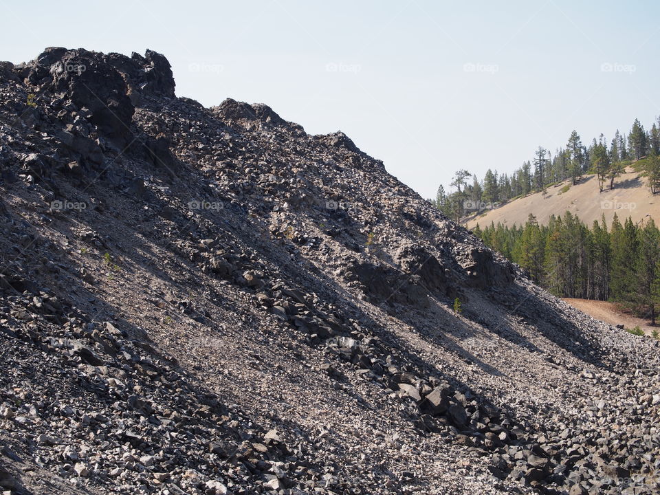 Textured Obsidian and hardened lava rock on a sunny fall day at the Big Obsidian Flow in the Newberry National Volcanic Monument in Central Oregon. 