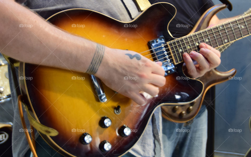 Working hands, playing guitar and bass