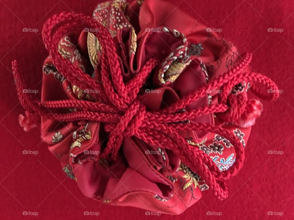 Red silk pouch on red background 