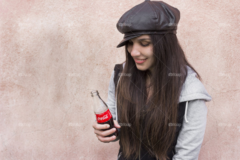 Woman holds coca-cola bottle