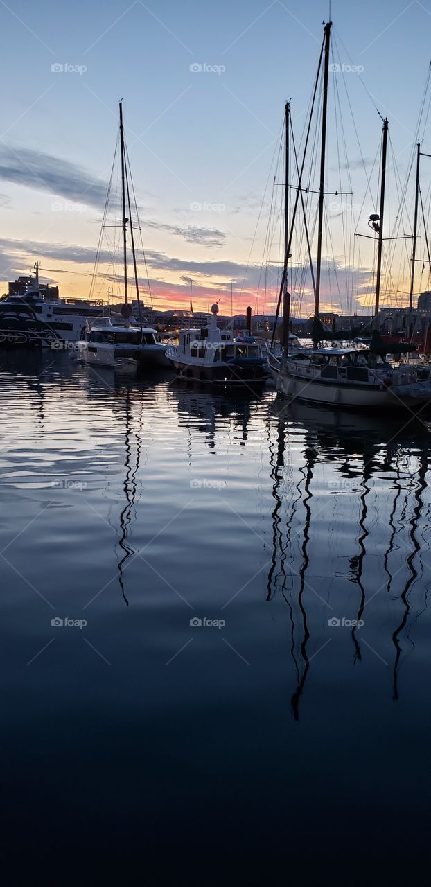 Boat reflection in ocean harbour