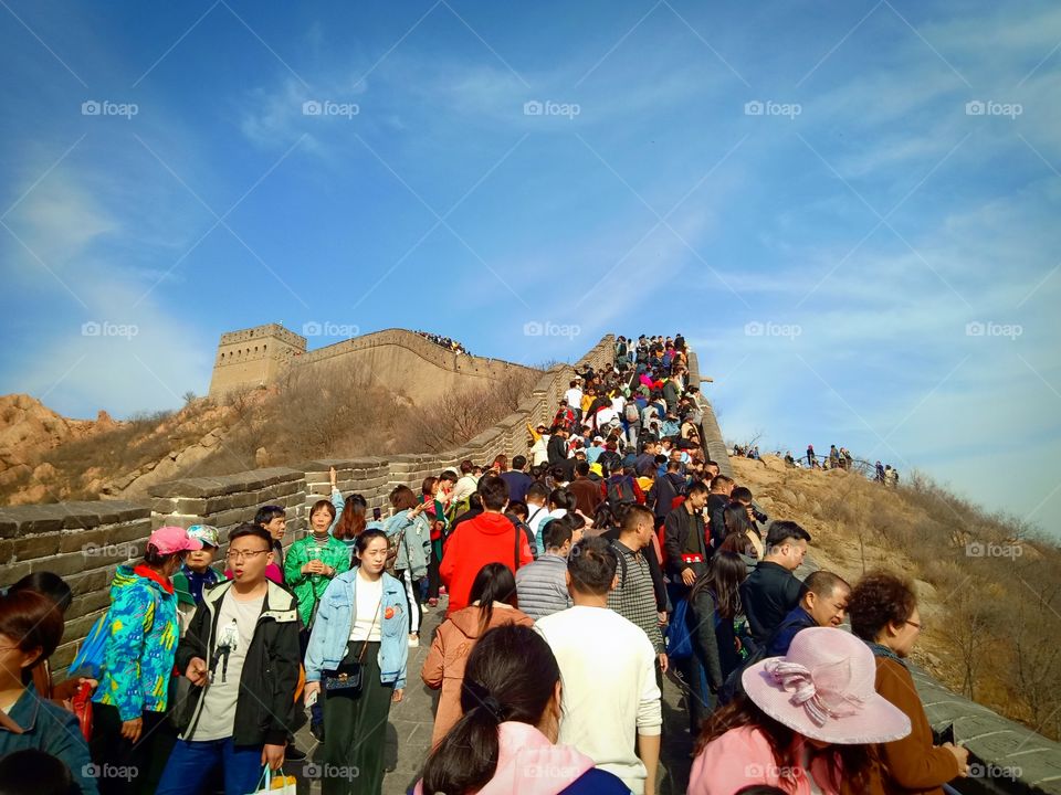 People Walking on bridge at Great Wall of China to final seventh stage