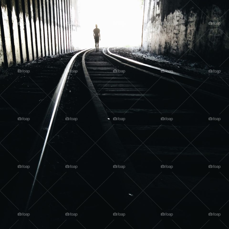 A person walking on railroad track