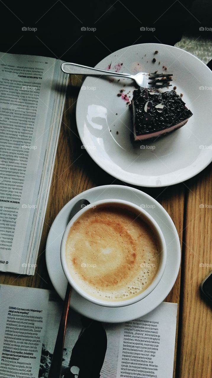 Coffee, piece of cake and newspaper