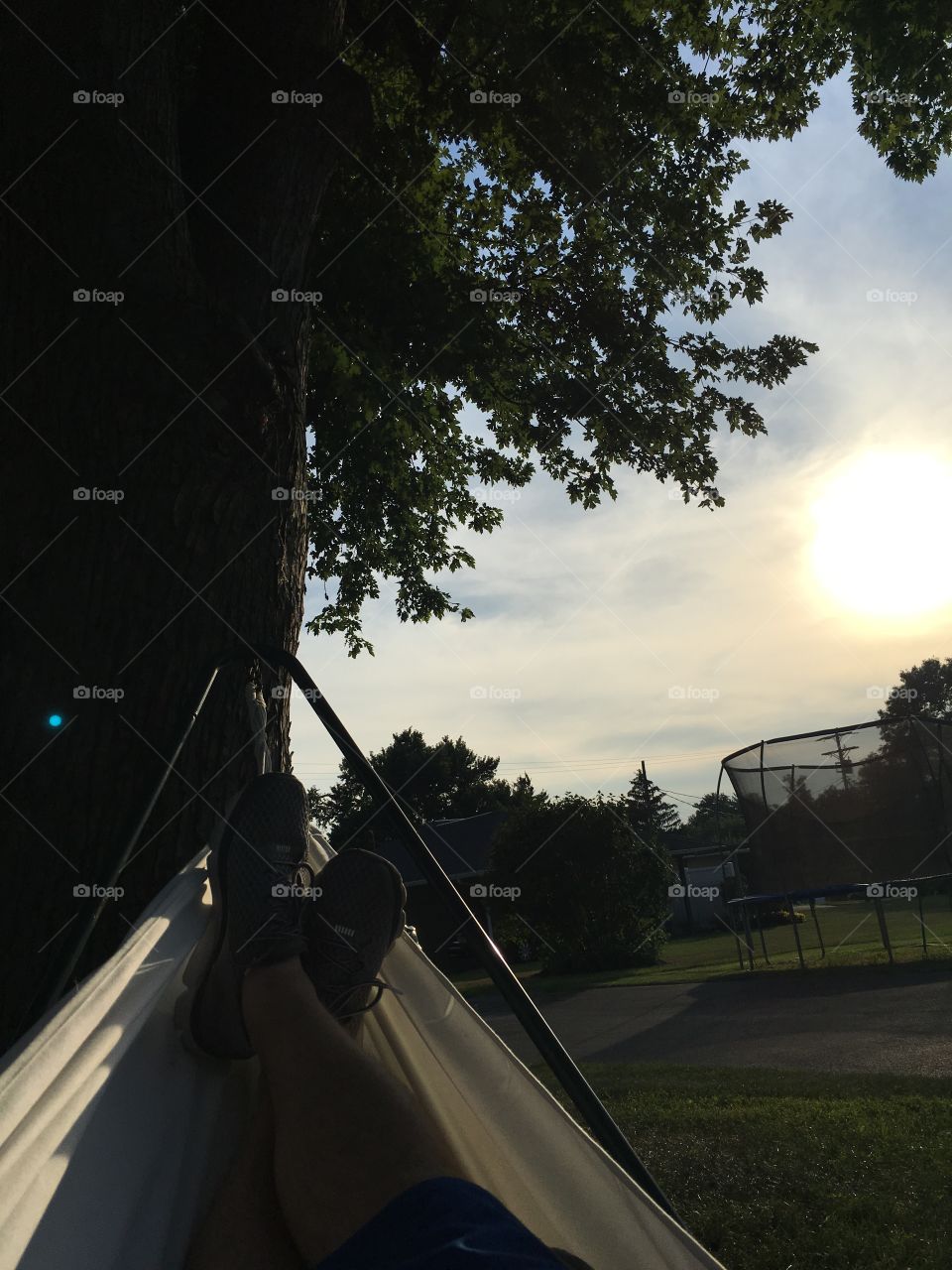 Relaxing in a hammock while the sun sets on a summer evening in Pennsylvania 