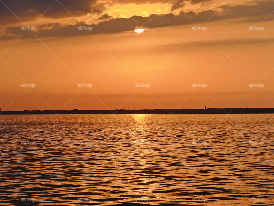 The sunset was a perfect conclusion of the day. It was silky, smooth collusion of sky burst reds, yellows, various hues, orange, tangerine and metallic gold