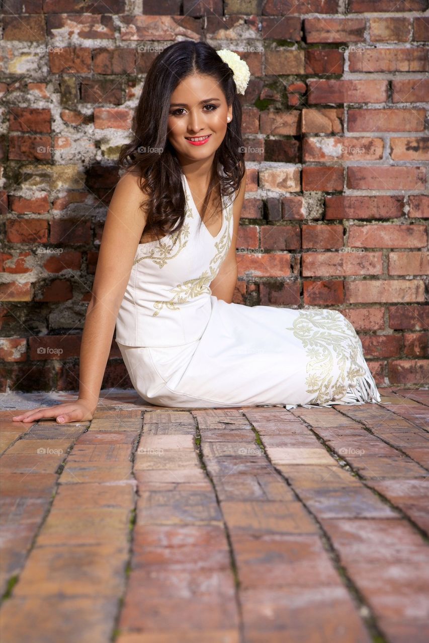 Cute young girl sitting on the ground