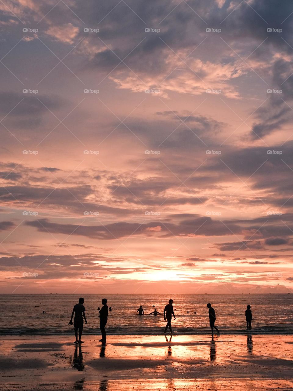 People gathers on the beach enjoying the beautiful sunset in Langkawi, Malaysia