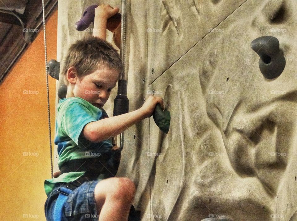 Boy Climbing Rock Wall