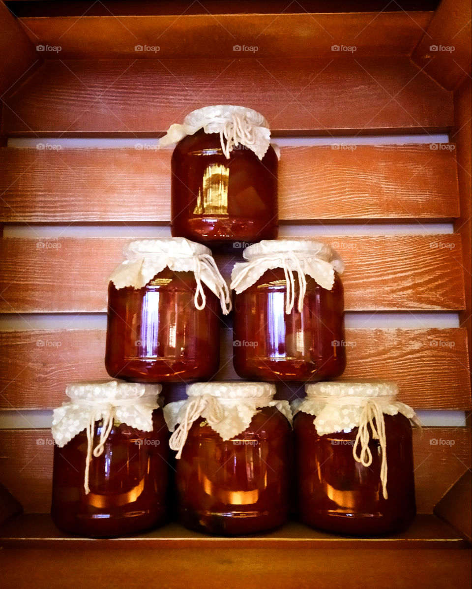 Six glass jars for the winter with salted tomatoes in tomato sauce