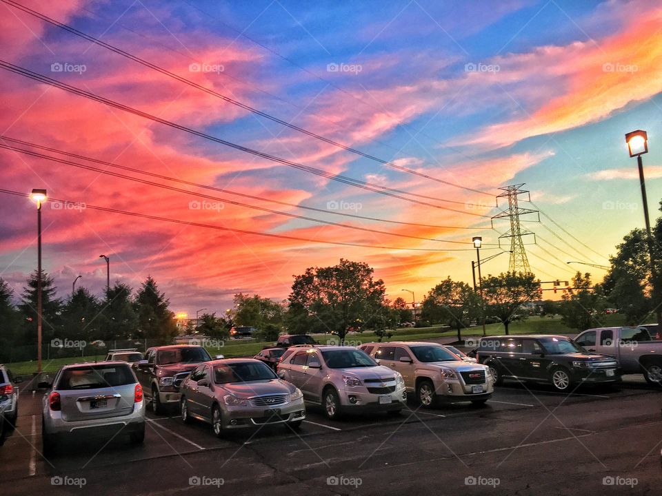 Parking lot with cars during sunset
