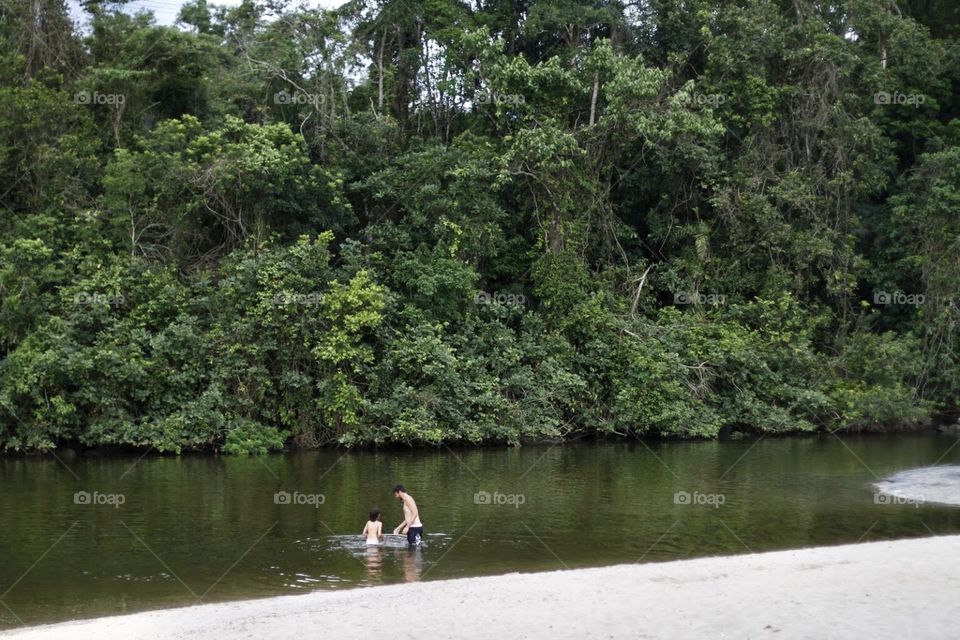 Boys playing in the river water