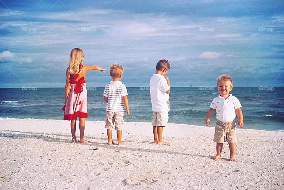 Brothers, Sister, and baby on the beach