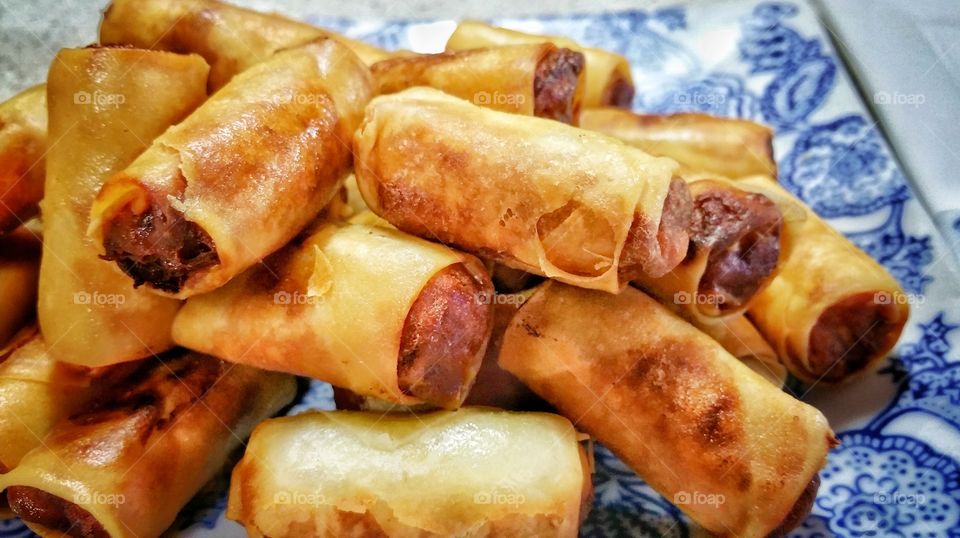 Homemade Chinese mini spring rolls - pastry usually filled with a combination of vegetables and meat before deep frying till golden brown in color. The finished rolls are allowed to rest a little prior to consumption.
