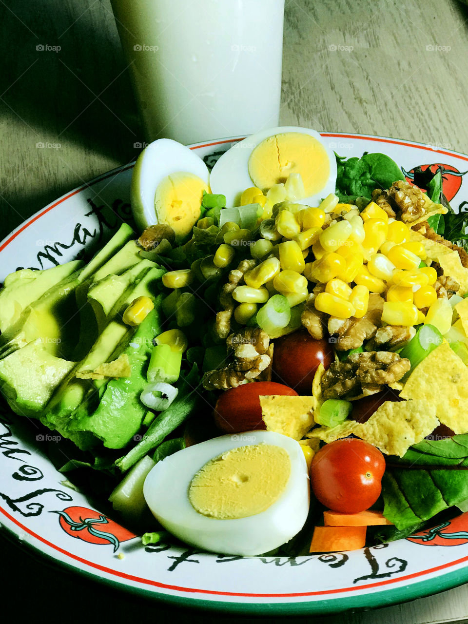 My version of a Cobb salad; mixed greens, leftover Easter eggs, corn, avocado, chicken, grape tomatoes, sliced carrots, green onions, walnuts, crumbled corn chips. And a glass of milk. Yum!