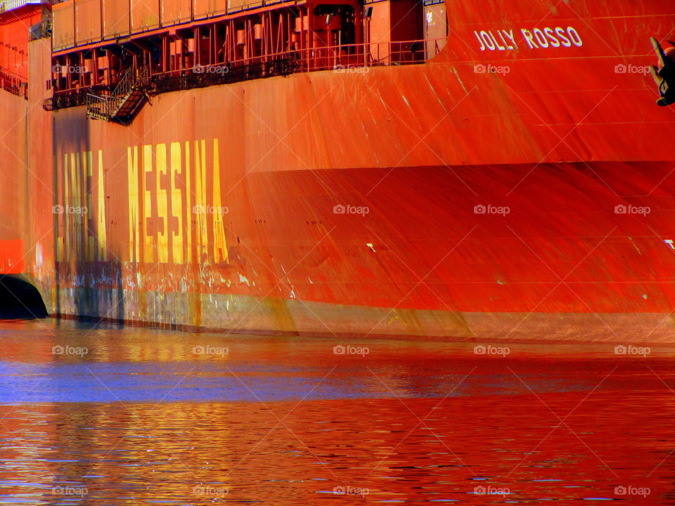 red tanker broadside and its water reflection