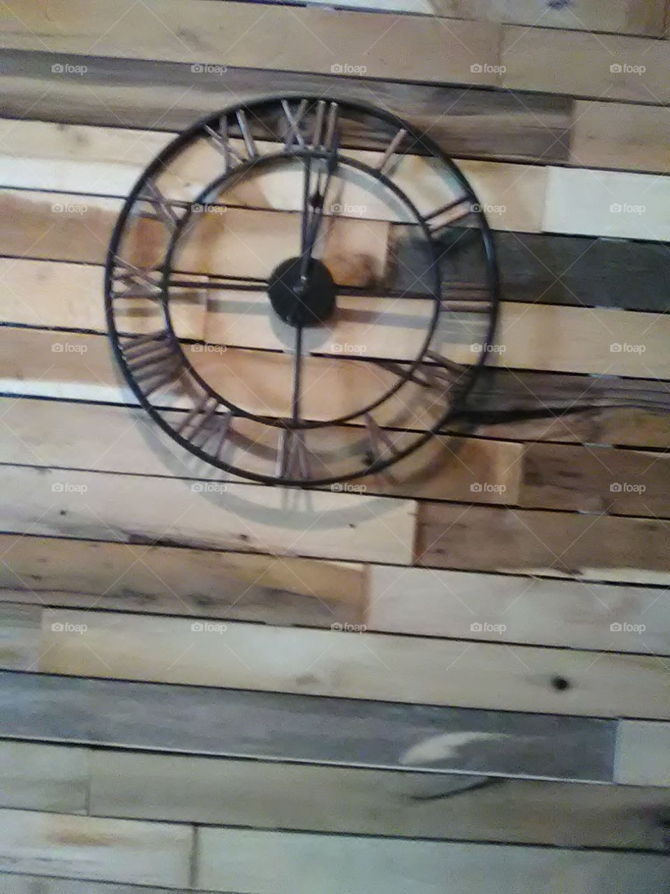 Metal Wall Clock On Rustic Wall