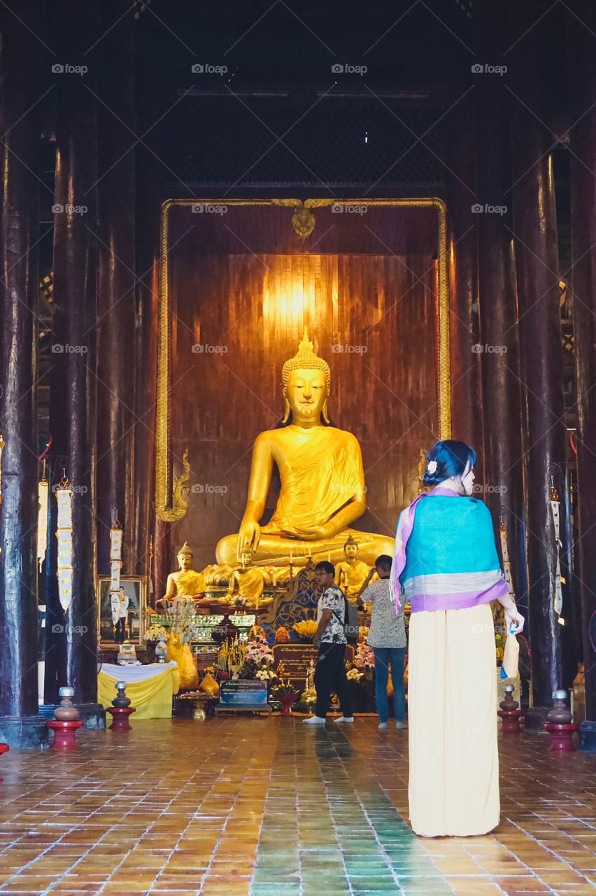 Woman entering a temple in Chiang Mai, Thailand 