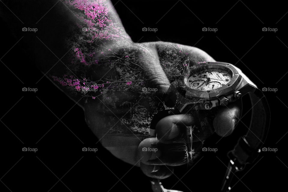 This is a double exposure of a watch and a landscape. The blossoms of the pink contrasts really well against the sharp black and whites