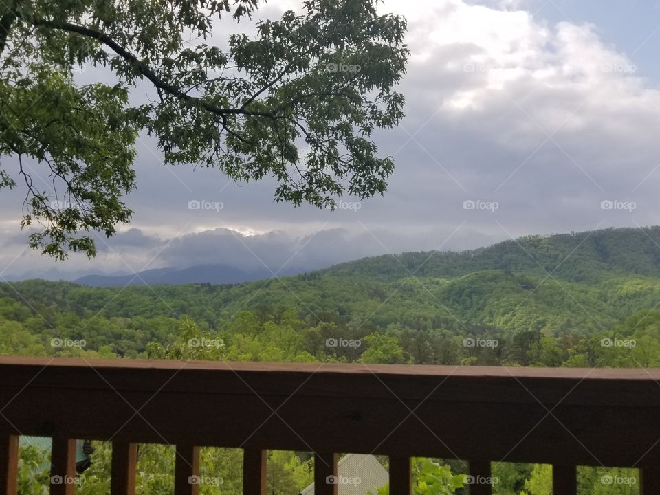 Gloomy rolling clouds of dark stormy sky views over Smoky mountains of Gatlinburg, Tennessee.