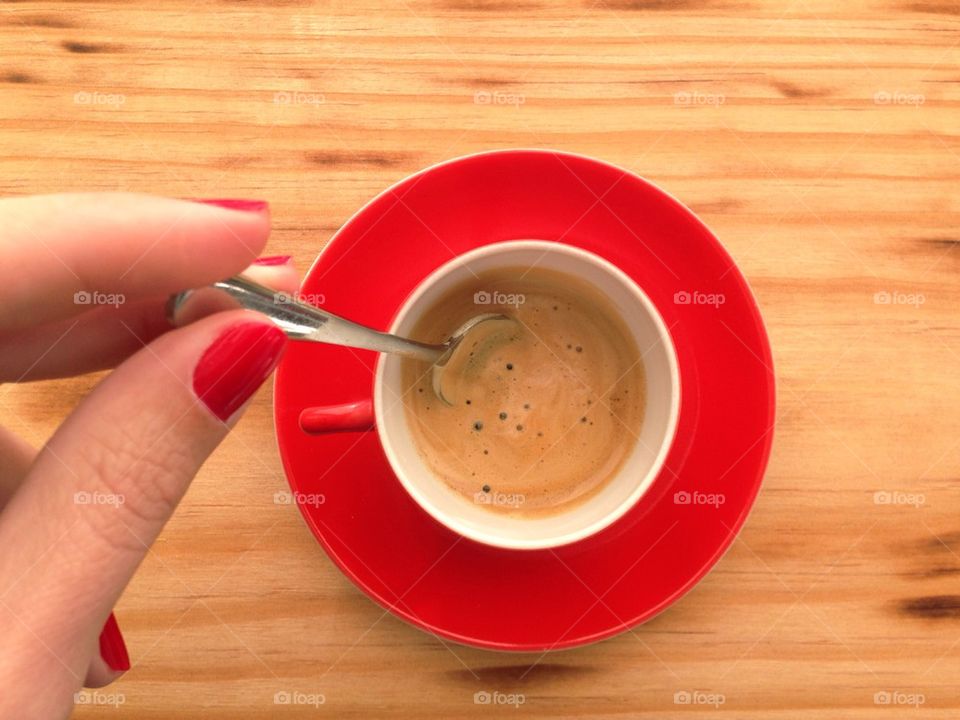 Woman stirring a cup of coffee 