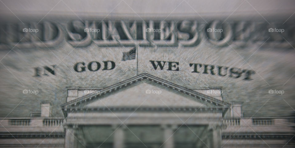 close of an American us dollar bank note mentioned in God we trust