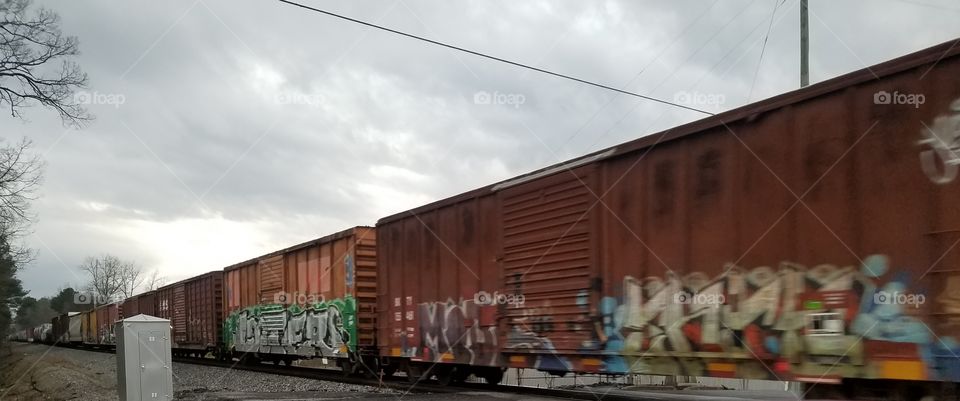 a long train with graffiti