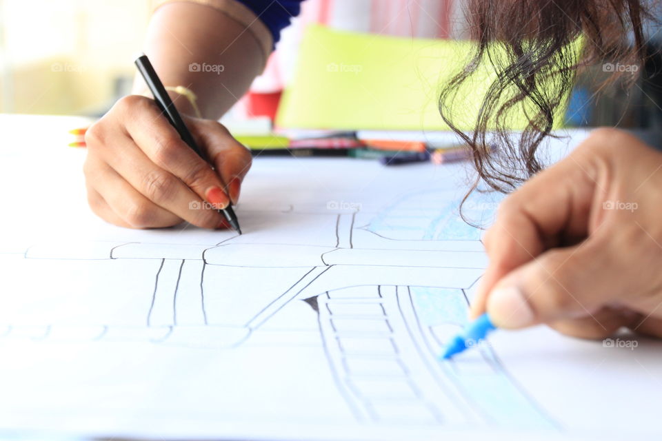 Lady drawing the architecture plan