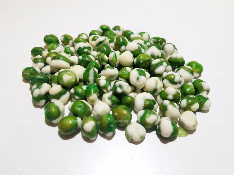 Wasabi peas on a white background