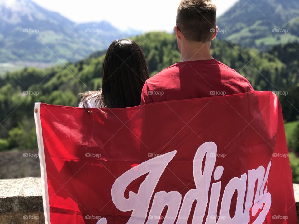College students holding school flag on study abroad trip to Switzerland. 