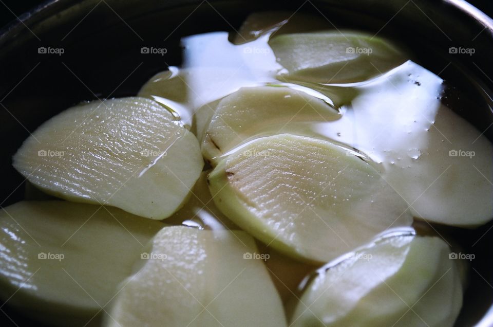 Sliced potatoes ready to boil