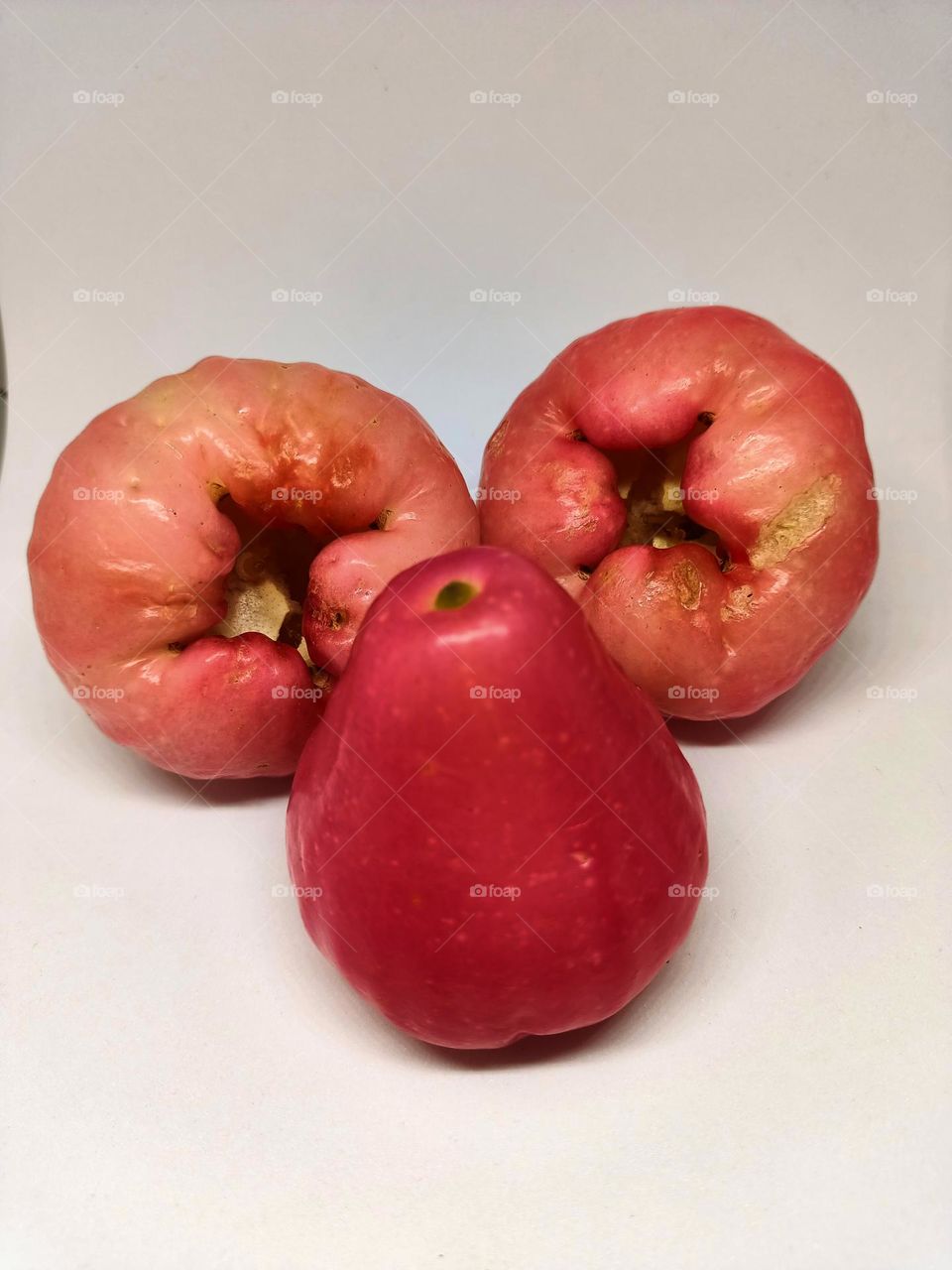 Close up of wax apple isolated on white background. Selective focus, underexposed, blurry, low light, too soft