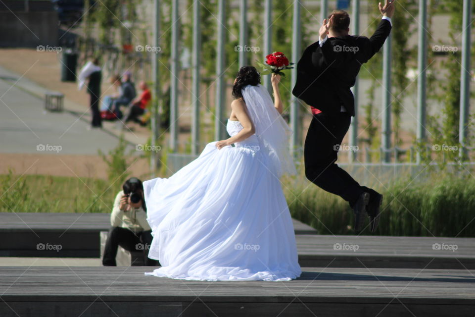 let's jump. bride and groom