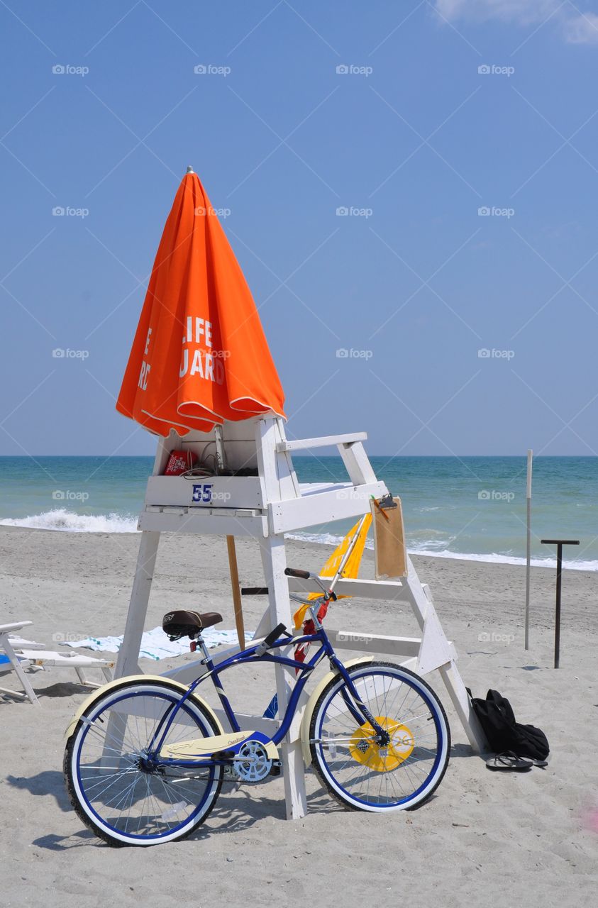 Lifeguard chair and Bicycle at the beach.