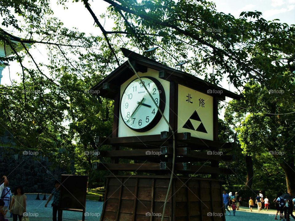 Clock in the green garden in Japan