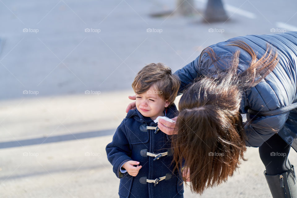 Close-up of a woman consoling her kid