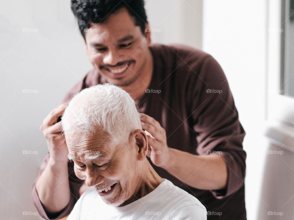 Grandson giving grandad a haircut
