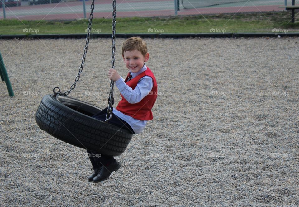 Playing in the playground even though you are dressed up 