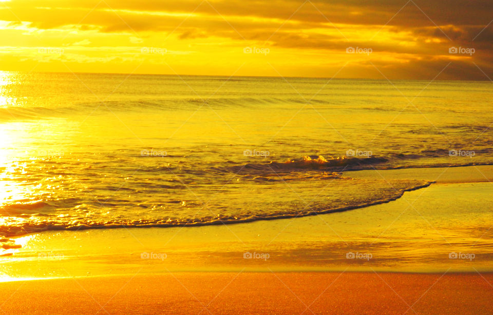 Radiant Glow Sunset. Golden bronze waves,orange-tangerine sky makes this sunset magnificently radiant!