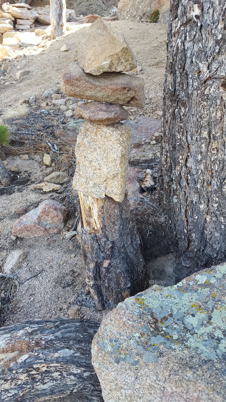 cairn made out of a tree stump and rocks