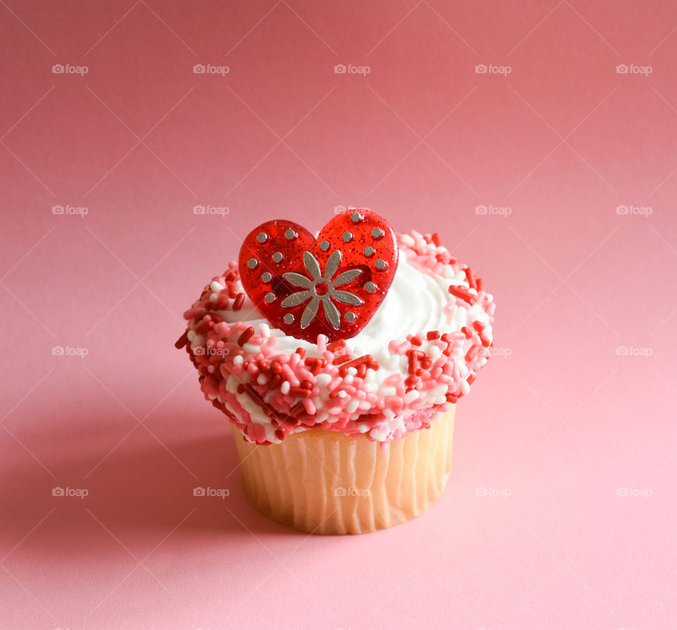 Decorative cupcake against a pink background