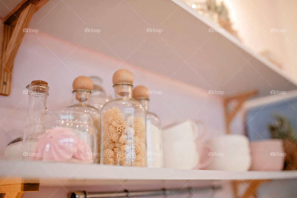 Festive winter cozy kitchen interior with garlands, decorations and gifts.  Christmas dinner at the decorated table.