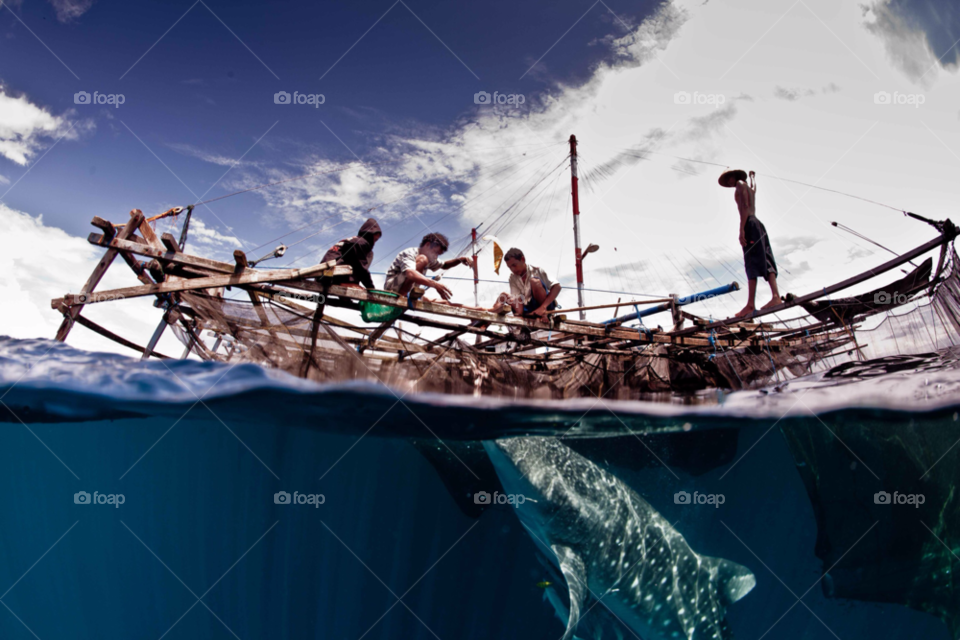 west papua fisherman underwater indonesia by paulcowell