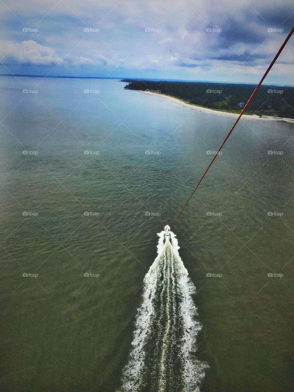 While parasailing over the Atlantic Ocean in the summer. High up on a sunny and beautiful day. 