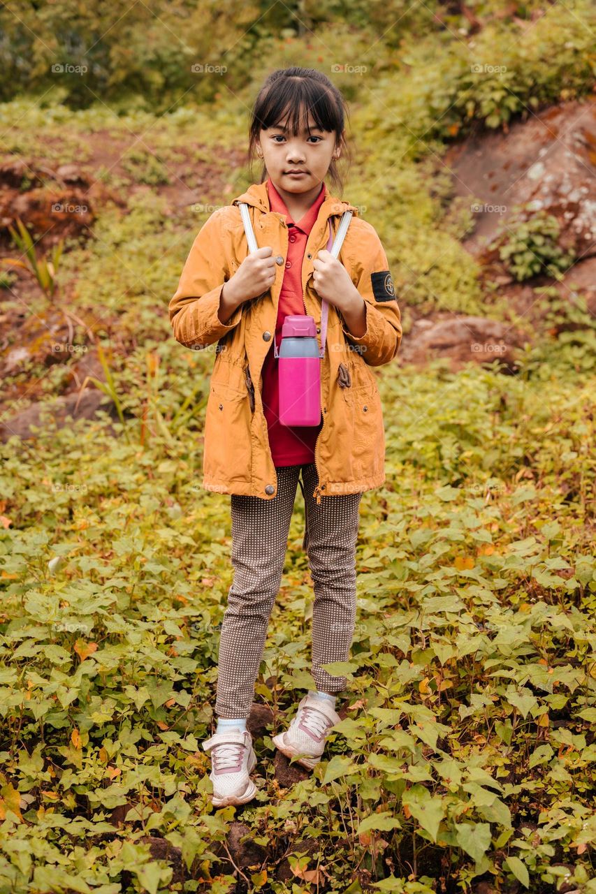 A simple portrait of a little young girl who is all set for a hike. Here in my part of the world October is the time for hiking or picnic time. Ukhrul, Manipur, India.