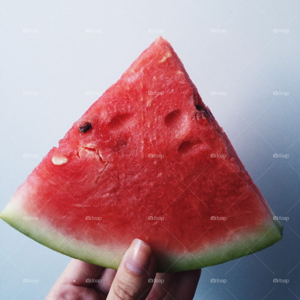 Close-up of a person holding watermelon