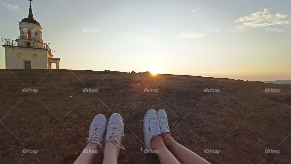 happy moments, walking with a friend, sunset, church, mountains nature, women's legs in sneakers, feet on the grass, sun, sky, summer